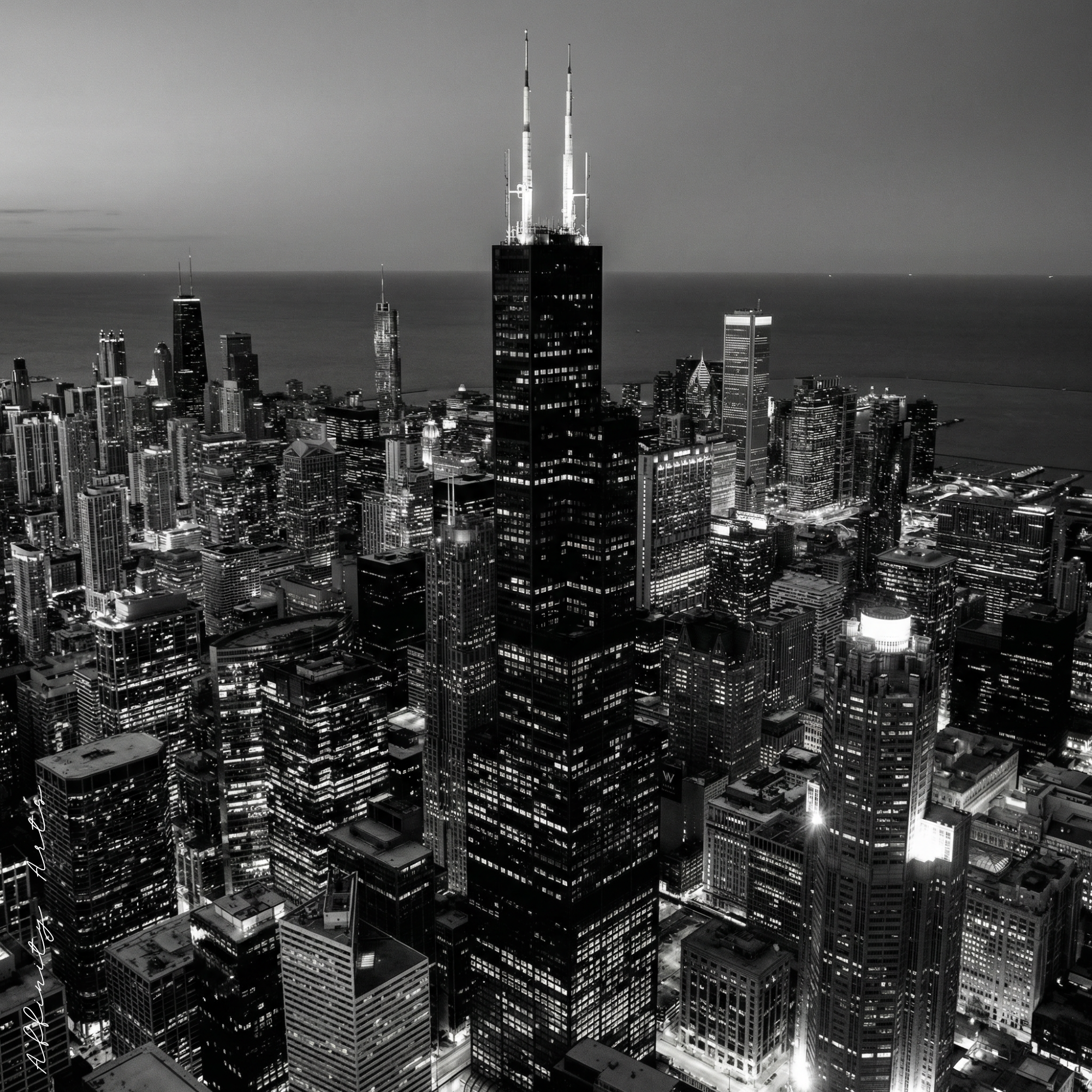 Aerial black and white photo of Chicago skyline at night with Willis Tower in the center