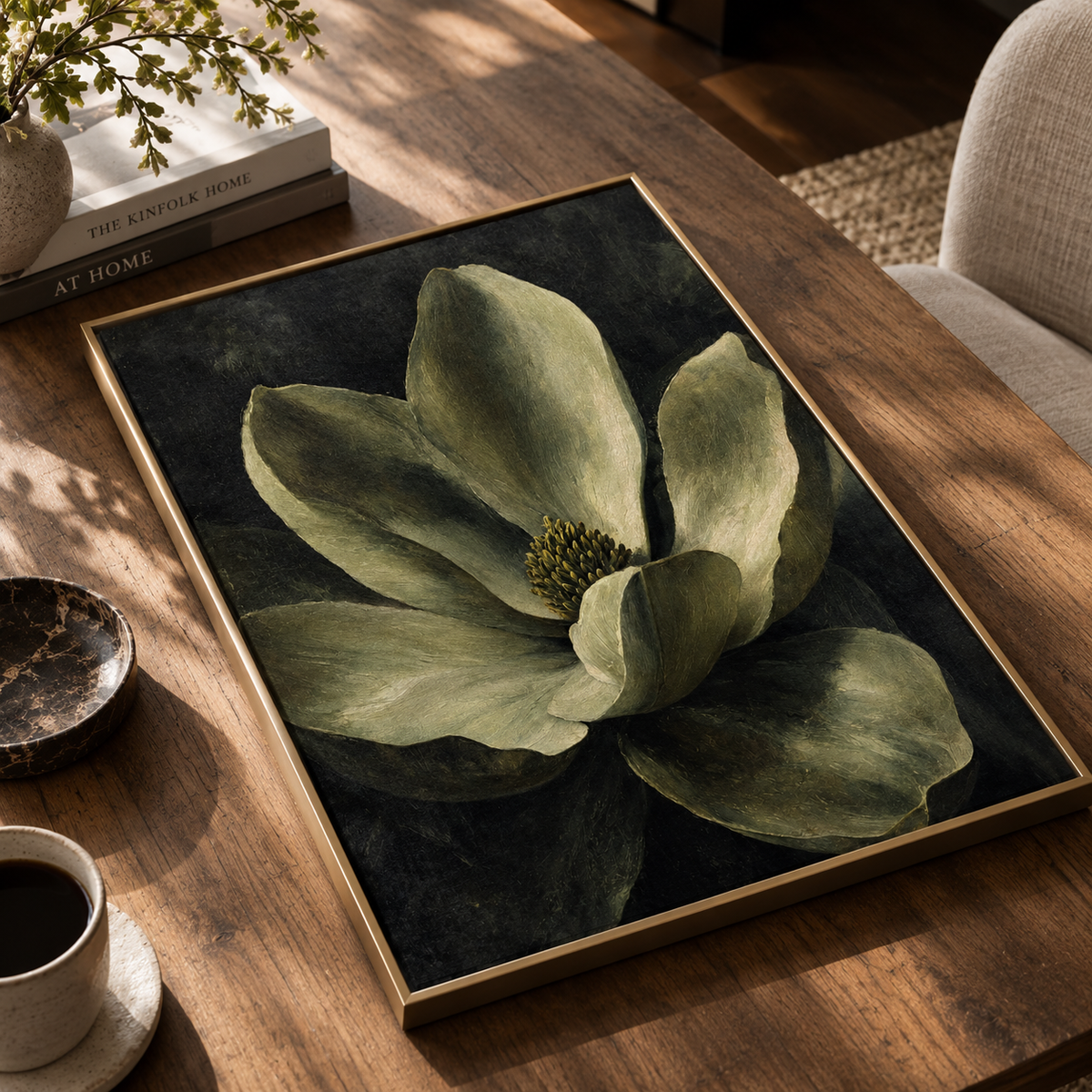 Dark botanical magnolia wall art displayed above a sofa in a living room with neutral tones