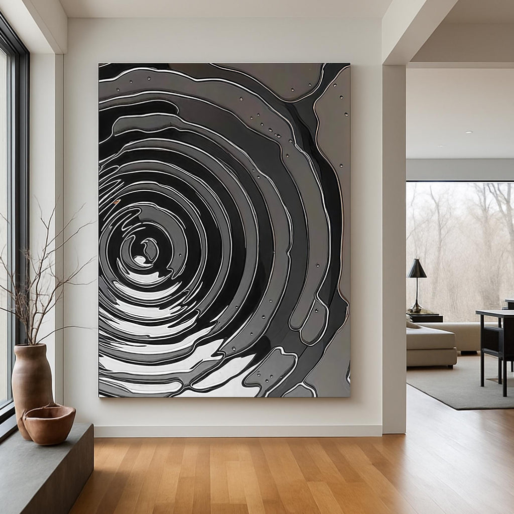 Sleek modern artwork showing concentric liquid rings with reflective surfaces

