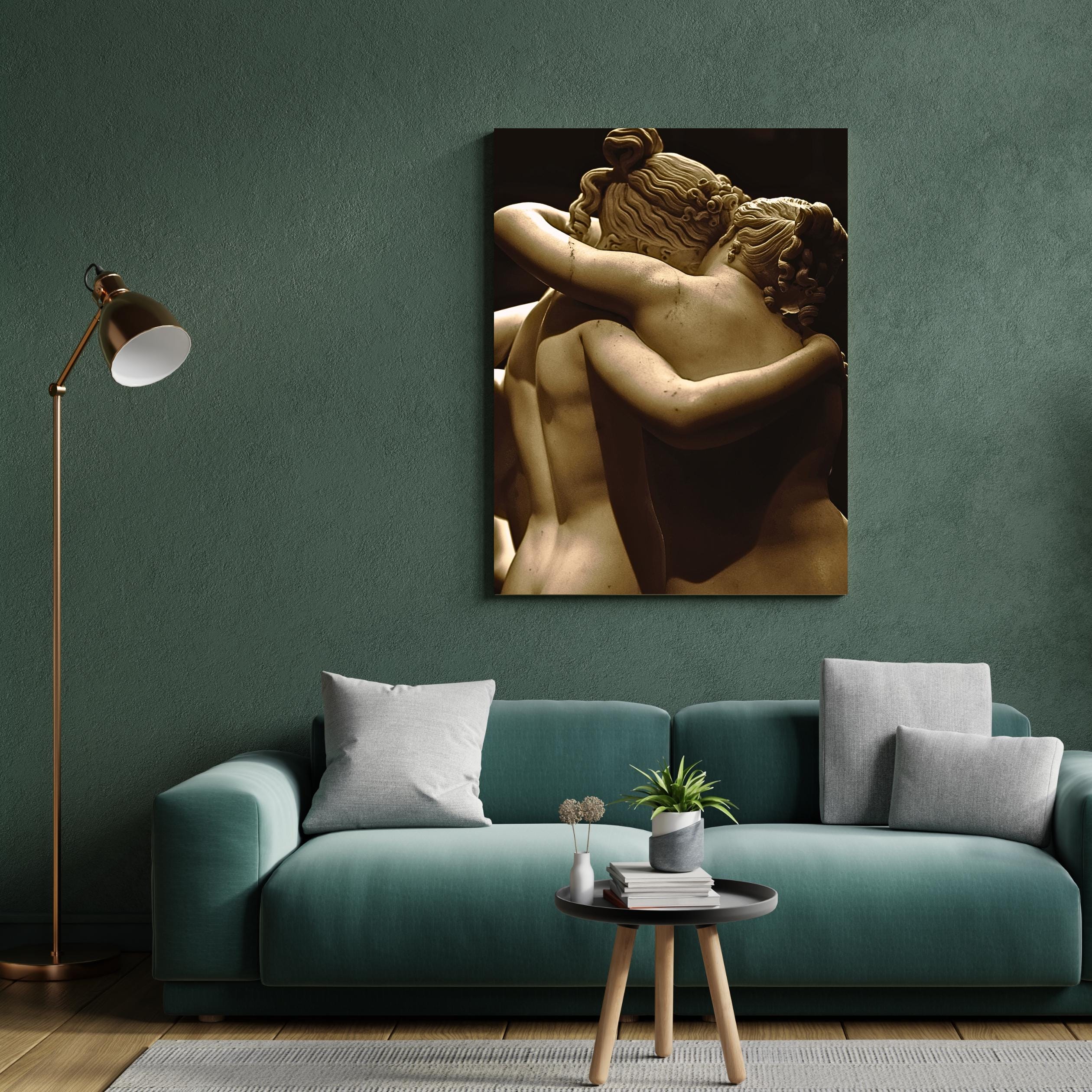 Detailed carving of two bare-shouldered women in tender embrace.